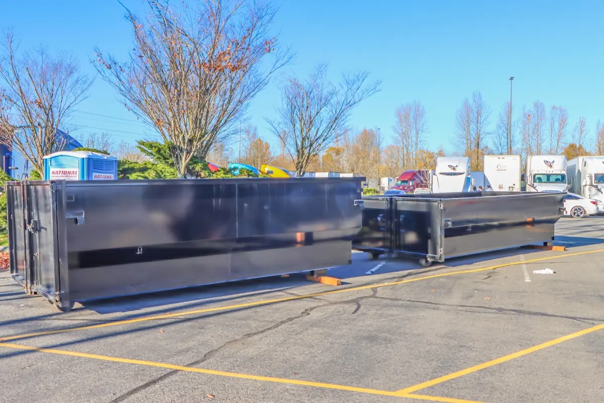 Professional dumpster rental service with roll-off container on residential driveway in Clinton